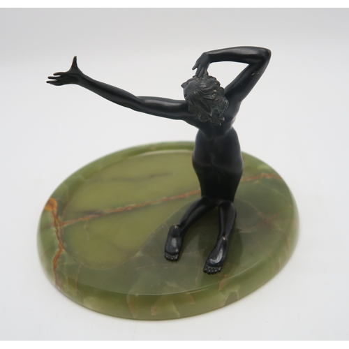 2260 - A FRENCH ART DECO BRONZE FIGURE OF A NUDEmodelled kneeling with arm outstretched, upon large circula... 