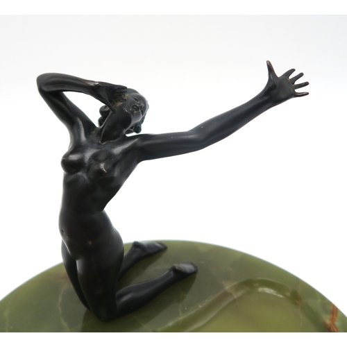 2260 - A FRENCH ART DECO BRONZE FIGURE OF A NUDEmodelled kneeling with arm outstretched, upon large circula... 