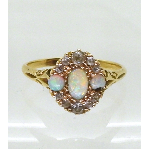 2778 - AN 18CT GOLD VINTAGE RINGset with three opals and old cut diamonds. With galleried mount and scroll ... 