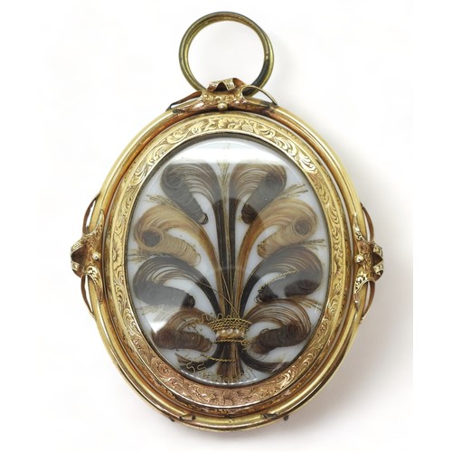 2707 - MOURNING PENDANT BROOCHwith glazed hair art panel, embellished with gold thread and pearls, in flowe... 