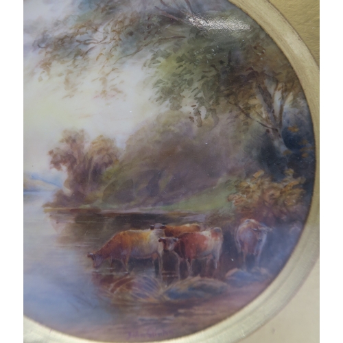 2263 - JOHN STINTON (1854-1956) A ROYAL WORCESTER PORCELAIN PLAQUEPainted with cattle by a river with a hil... 