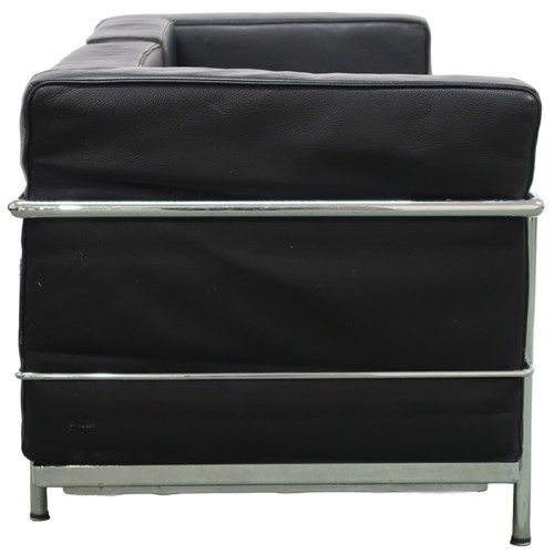 2101 - A 20TH CENTURY AFTER LE CORBUSIER TWO SEATER SETTEE with black leather cushions on chromed tubu... 