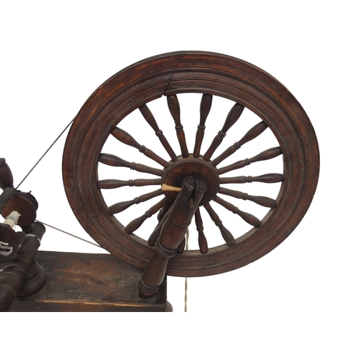 2038 - A 19TH CENTURY SCOTTISH SPINING WHEEL with 56cm turned spindle wheel on turned supports joined ... 