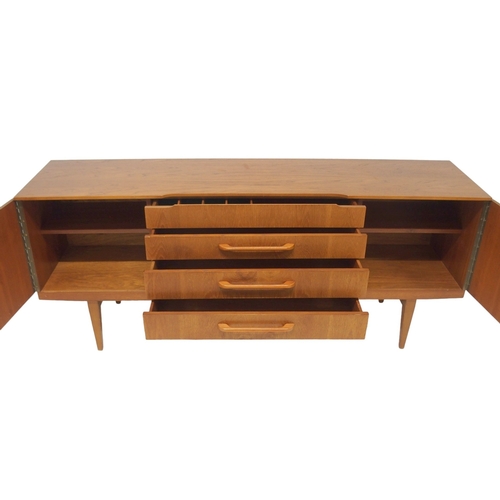 2095 - A MID 20TH CENTURY TEAK BEAUTILITY SIDEBOARD with four central drawers flanked by cabinet doors... 