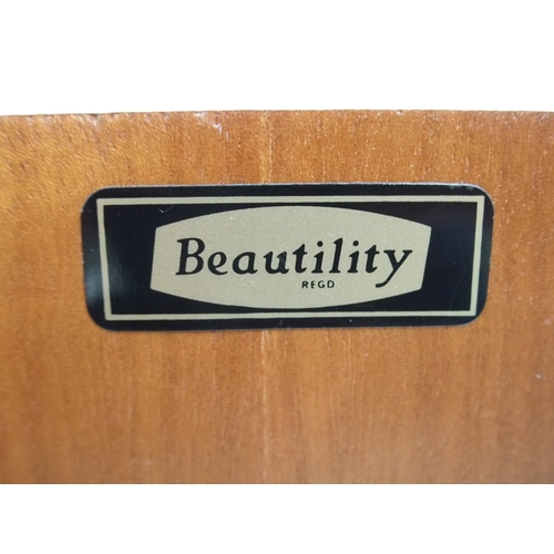 2095 - A MID 20TH CENTURY TEAK BEAUTILITY SIDEBOARD with four central drawers flanked by cabinet doors... 