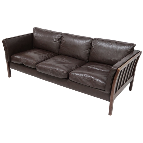 2106 - A 20TH CENTURY DANISH BROWN LEATHER UPHOLSTERED STOUBY THREE SEATER SETTEE with stained teak and lea... 