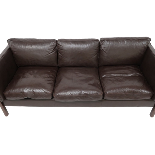 2106 - A 20TH CENTURY DANISH BROWN LEATHER UPHOLSTERED STOUBY THREE SEATER SETTEE with stained teak and lea... 