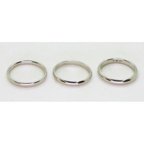 736 - Three platinum wedding bands, Size two are L1/2, one L, weight together 10.8gms