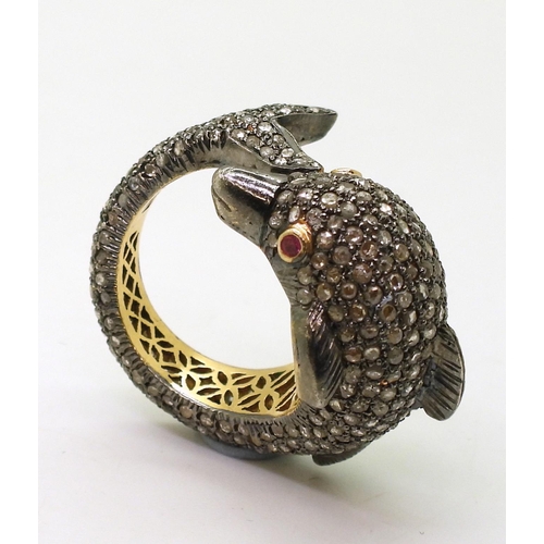 751 - A yellow and white metal dolphin ring completely pave set with rose cut diamonds, with ruby set eyes... 