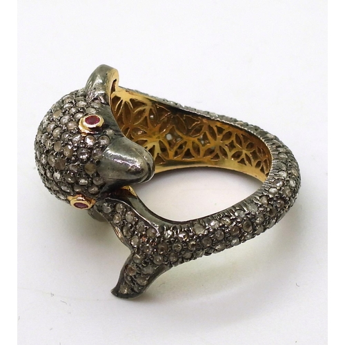 751 - A yellow and white metal dolphin ring completely pave set with rose cut diamonds, with ruby set eyes... 