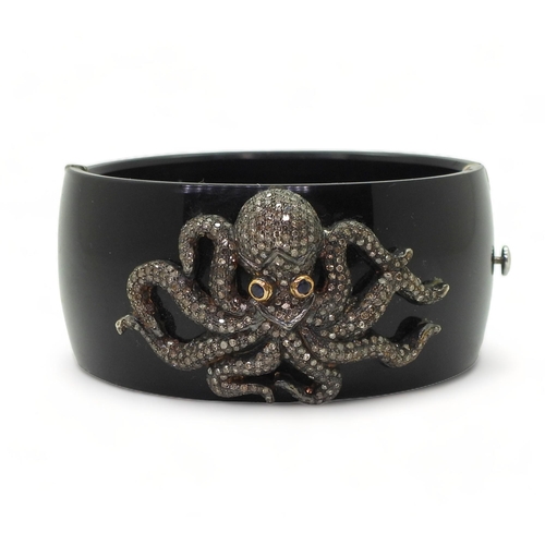 763 - An octopus bangle, the white and yellow metal octopus, is completely pave set with brilliant cut dia... 