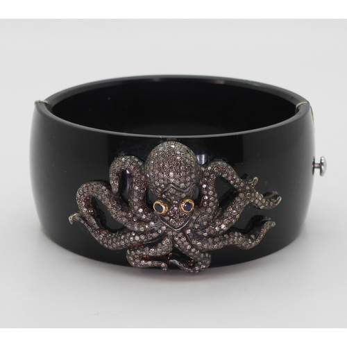 763 - An octopus bangle, the white and yellow metal octopus, is completely pave set with brilliant cut dia... 