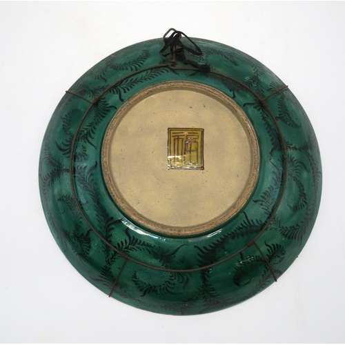 2392 - A JAPANESE CIRCULAR DISHPainted with a bird in flight above plantain on a cell pattern ground, 37cm ... 