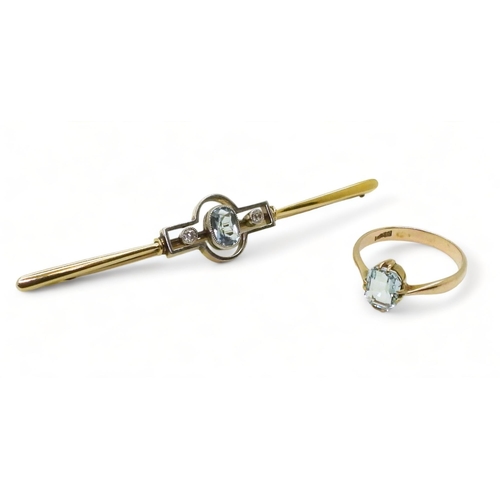 787 - A bright yellow metal and white metal bar brooch set with an aquamarine and two diamonds totaling 0.... 