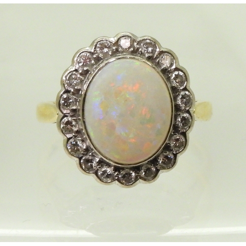 2792 - AN OPAL & DIAMOND CLUSTER RINGset with a 11mm x 9mm lively white opal, surrounded with estimated... 