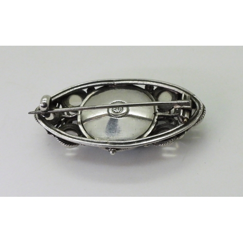 2795 - AN ARTS & CRAFTS BROOCHmade by Edmund Thomas Wyatt Ware (1883-1960) the white metal brooch is se... 