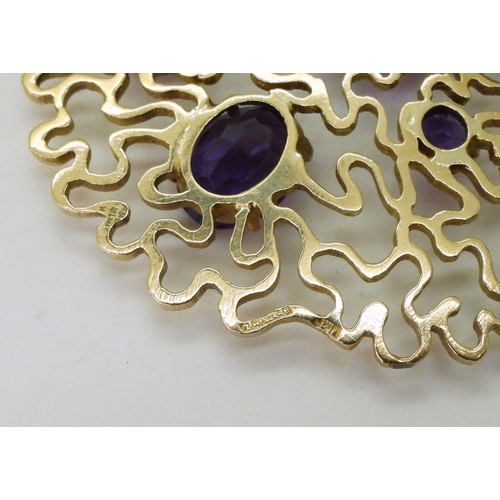 2796 - A RETRO AMETHYST BROOCHthe wriggle work design is set with round and oval mixed cut amethysts. Made ... 