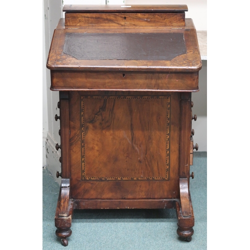 11 - A late Victorian walnut veneered Davenport writing desk with hinged top writing compartment over fou... 
