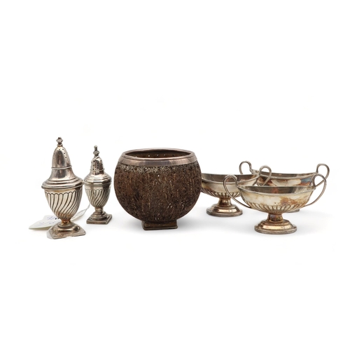 200 - A white metal mounted carved coconut cup, the base stamped 925, three plated salts and two casters (... 