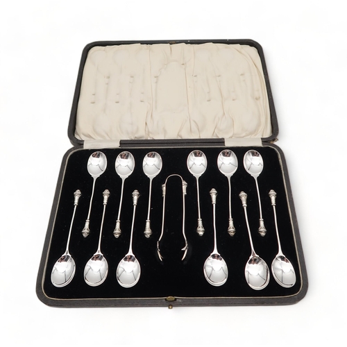 219 - A cased set of silver Arts and Crafts style teaspoons and sugar tongs, by Docker & Burn, Birming... 