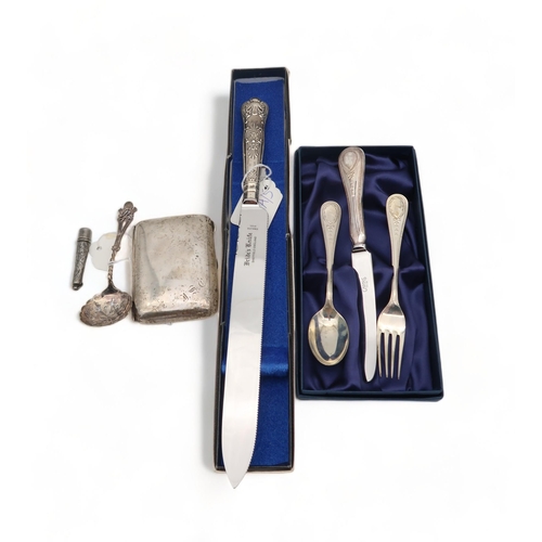 219A - A collection of silver cutlery including a christening set, by Carrs of Sheffield, a cheroot holder,... 