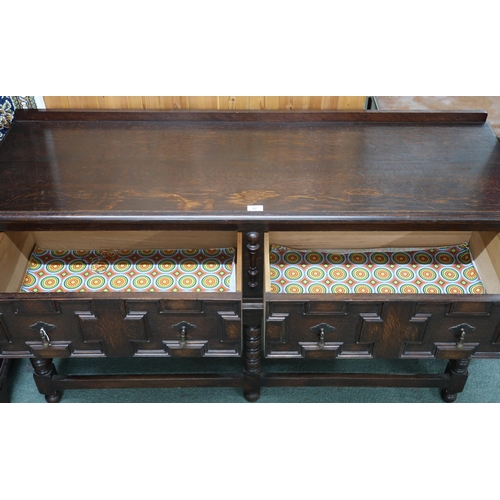 27 - A 20th century oak Jacobean style two drawer buffet table on turned supports joined by stretchers, 8... 