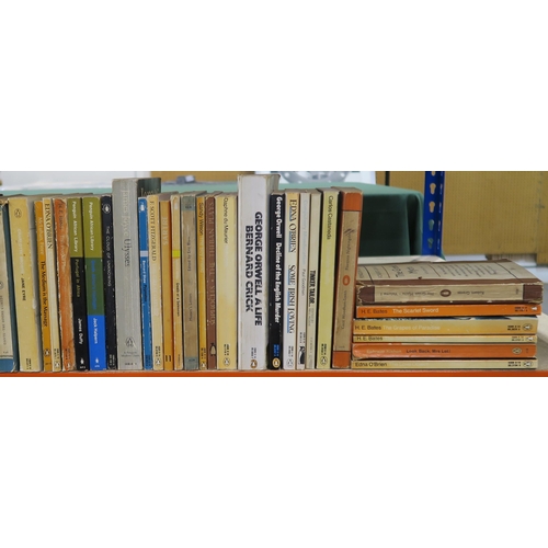 326 - Four shelves of assorted books, to include academic and theological titles, alongside paperback Peng... 