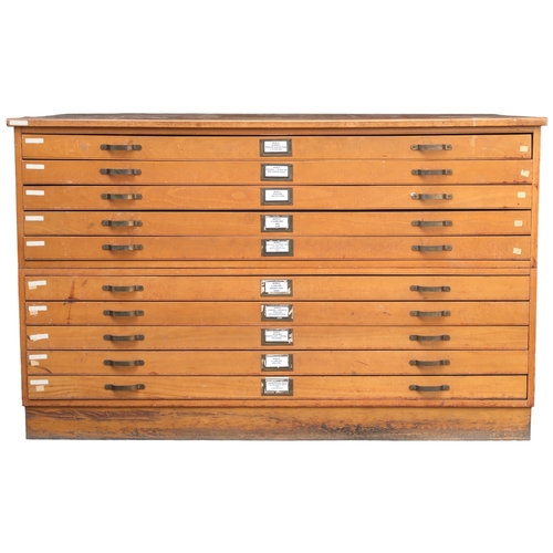 2114 - A 20TH CENTURY PITCH PINE PLAN CHEST with laminate top over ten narrow folio drawers on plinth base,... 