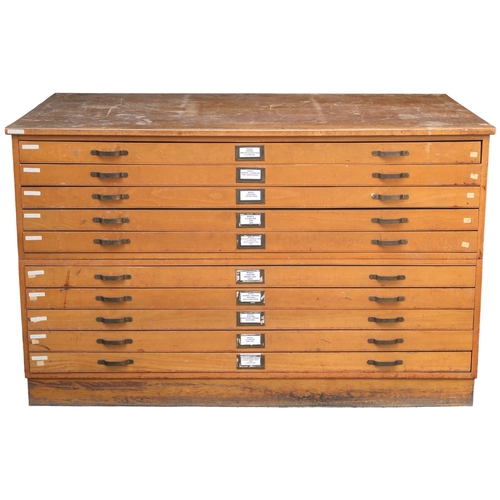 2114 - A 20TH CENTURY PITCH PINE PLAN CHEST with laminate top over ten narrow folio drawers on plinth base,... 