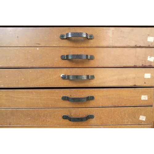 2114 - A 20TH CENTURY PITCH PINE PLAN CHEST with laminate top over ten narrow folio drawers on plinth base,... 