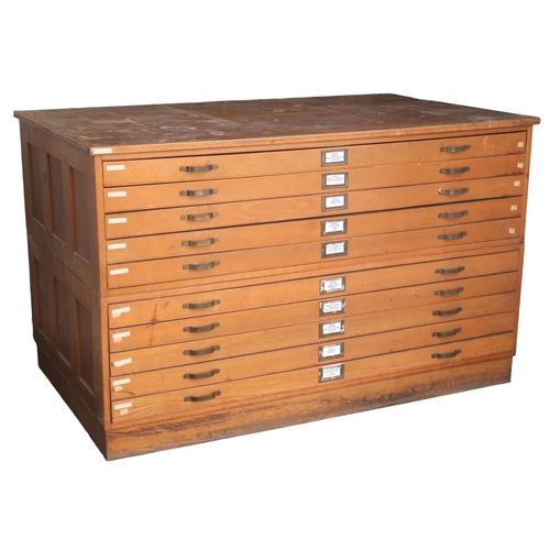 2114 - A 20TH CENTURY PITCH PINE PLAN CHEST with laminate top over ten narrow folio drawers on plinth base,... 