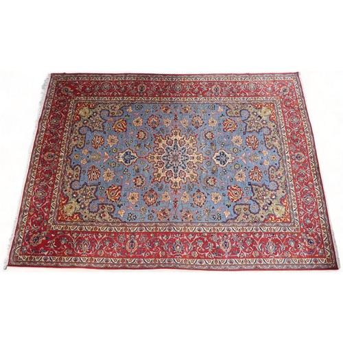 2137 - A LIGHT BLUE GROUND TABRIZ RUG with multicoloured sunburst central medallion on floral patterne... 