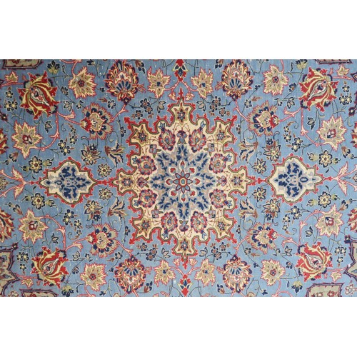 2137 - A LIGHT BLUE GROUND TABRIZ RUG with multicoloured sunburst central medallion on floral patterne... 