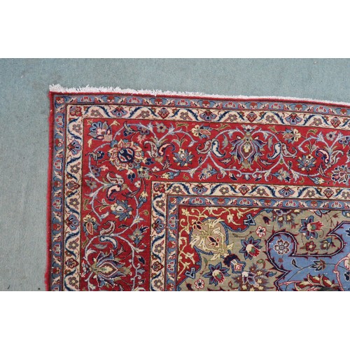 2137 - A LIGHT BLUE GROUND TABRIZ RUG with multicoloured sunburst central medallion on floral patterne... 