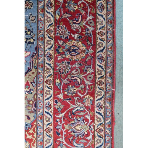 2137 - A LIGHT BLUE GROUND TABRIZ RUG with multicoloured sunburst central medallion on floral patterne... 