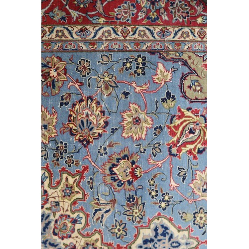 2137 - A LIGHT BLUE GROUND TABRIZ RUG with multicoloured sunburst central medallion on floral patterne... 