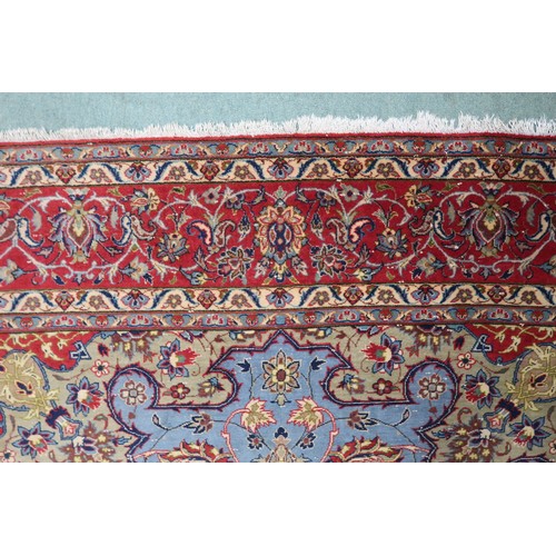 2137 - A LIGHT BLUE GROUND TABRIZ RUG with multicoloured sunburst central medallion on floral patterne... 