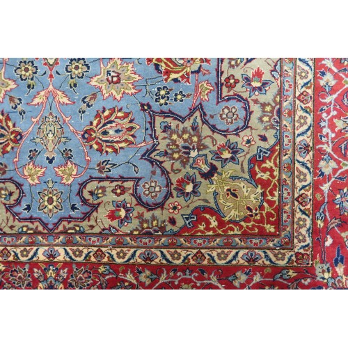 2137 - A LIGHT BLUE GROUND TABRIZ RUG with multicoloured sunburst central medallion on floral patterne... 