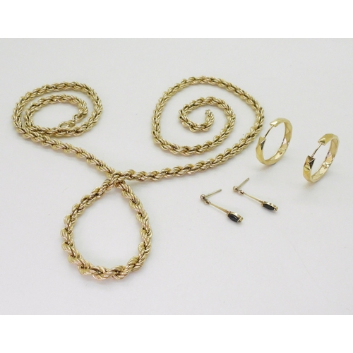 712 - A 9ct gold rope chain, length 77cm, a pair of 9ct gold hoop earrings, and a pair of yellow metal sap... 