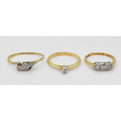 715 - Three 18ct diamond rings, a 0.06ct solitaire size K, a illusion set three stone, size J, and a (af) ... 