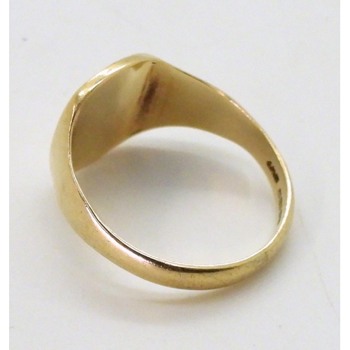 723 - A 9ct gold signet ring, size V, weight 5gms