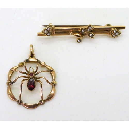 771 - A 9ct gold garnet set spider pendant, diameter 2.2cm and a 9ct gold brooch, weight together 4gms