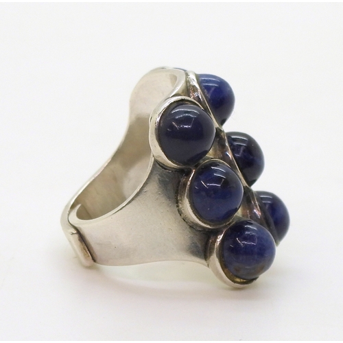 2802 - TWO RETRO NORWEGIAN JEWELSa silver ring by Uni David Andersen, set with nine lapis lazuli cabochons,... 