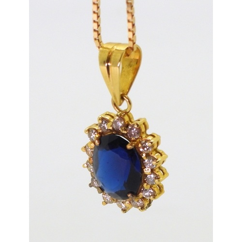 2803 - AN ARABIC PENDANT AND CHAINthe pendant is set with blue and clear gems, and made in bright yellow me... 