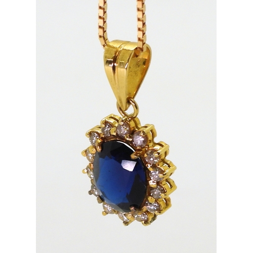 2803 - AN ARABIC PENDANT AND CHAINthe pendant is set with blue and clear gems, and made in bright yellow me... 