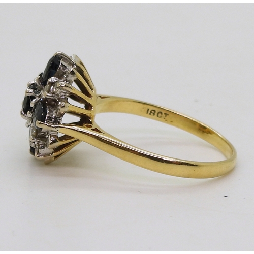 2812 - A SAPPHIRE & DIAMOND CLUSTER RINGwith a classic 18ct gold basket setting. set with four oval sap... 