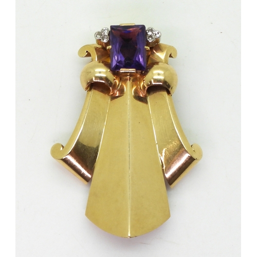 2814 - A FLEUR DE LIS DRESS CLIPmade in 14k gold and platinum, set with a mixed cut amethyst and diamond ac... 