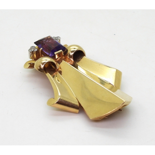 2814 - A FLEUR DE LIS DRESS CLIPmade in 14k gold and platinum, set with a mixed cut amethyst and diamond ac... 