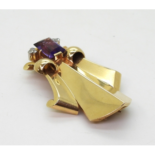 2814 - A FLEUR DE LIS DRESS CLIPmade in 14k gold and platinum, set with a mixed cut amethyst and diamond ac... 