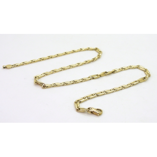 2821 - A 9CT GOLD FANCY CHAINof twisted baton links, length 44.5cm, weight 24.9gms